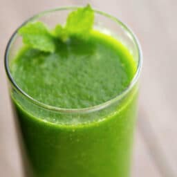 a close up of spinach smoothie in a glass