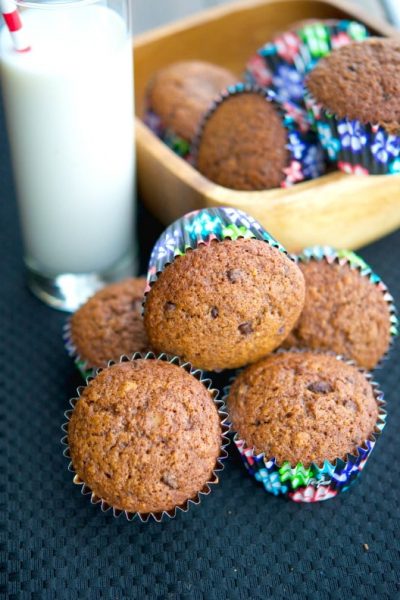 Hazelnut Chocolate Chip Banana Muffins on a table with milk.