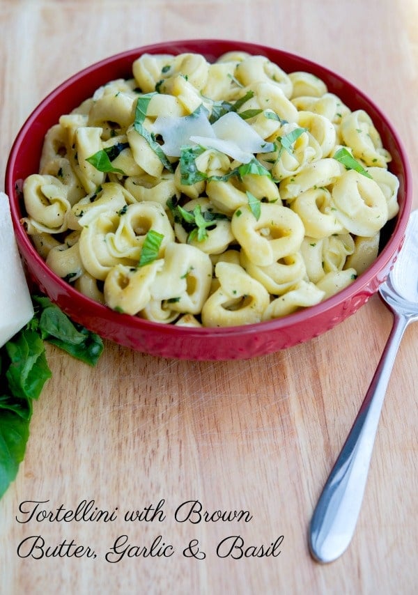 A bowl of food on a table, with Tortellini and Garlic