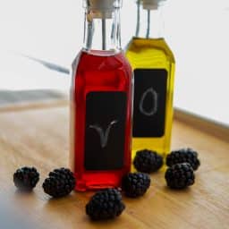 Glass bottles filled with homemade blackberry vinegar