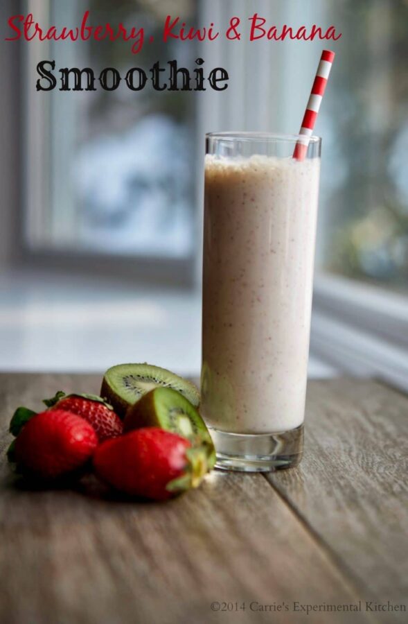 A cup of strawberry, kiwi and banana smoothie on a table