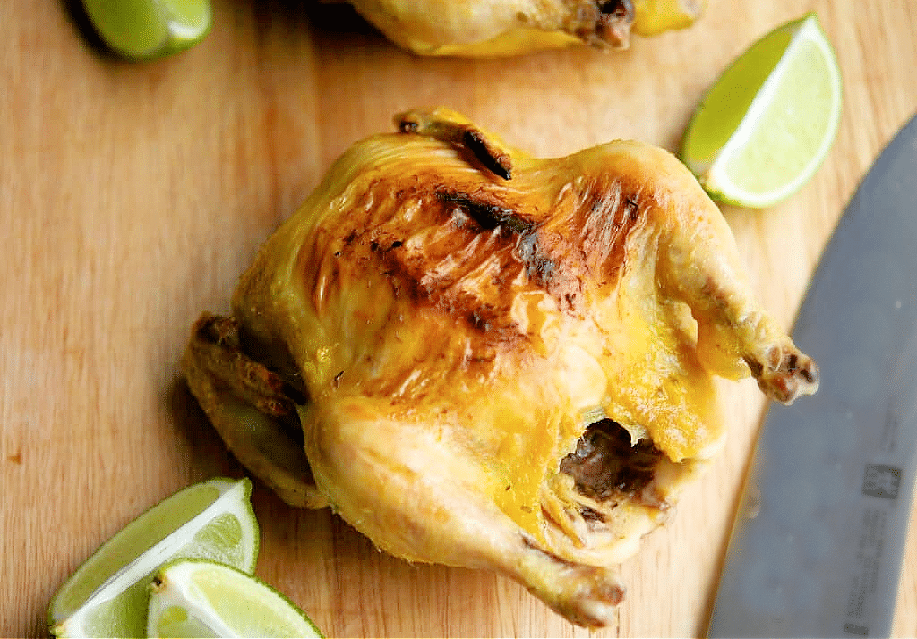 a close up of cornish hen on a board