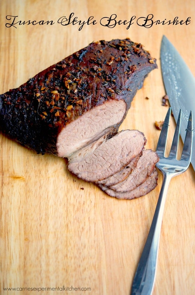 Tuscan Beef Brisket sliced on a wooden cutting board. 