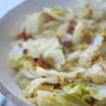 This recipe made with sautéed cabbage, bacon, fresh thyme and white wine is delicious and makes a tasty vegetable side dish.