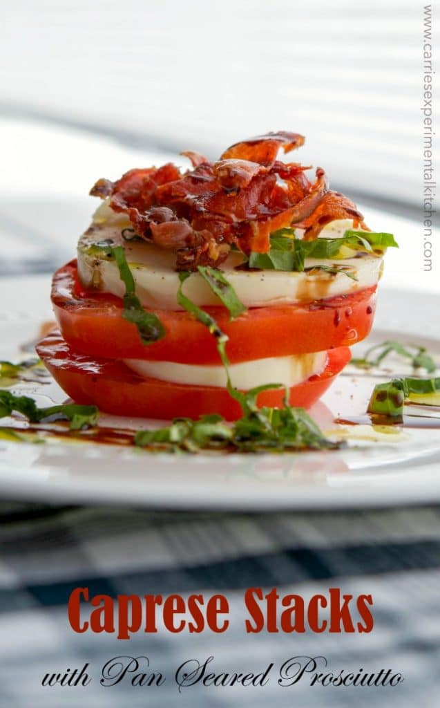 A plate of fresh mozzarella and tomatoes stacked; then topped with pan seared prosciutto.