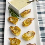 fried artichoke hearts on a white platter