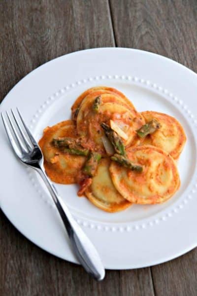 A plate with ravioli and asparagus