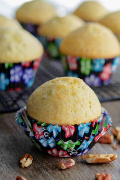 lemon pecan muffins in a black paper wrapper