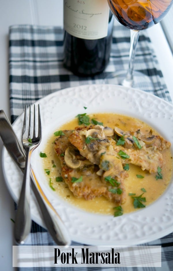 A plate of pork marsala on a table 