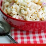 Macaroni salad in a red bowl.