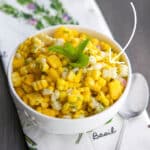 This Tropical Corn Salad made with fresh corn on the cob, mangoes, fresh mint and pineapple juice is light and refreshing.