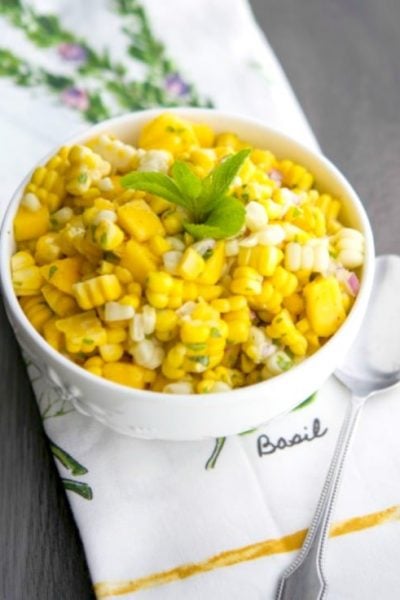 This Tropical Corn Salad made with fresh corn on the cob, mangoes, fresh mint and pineapple juice is light and refreshing. 