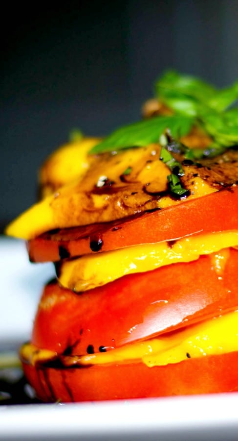 Sweet mangoes and fresh, ripened Heirloom Jersey tomatoes stacked, then topped with a balsamic reduction.