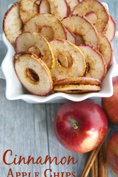 Cinnamon Apple Chips  in a bowl on a wooden table.