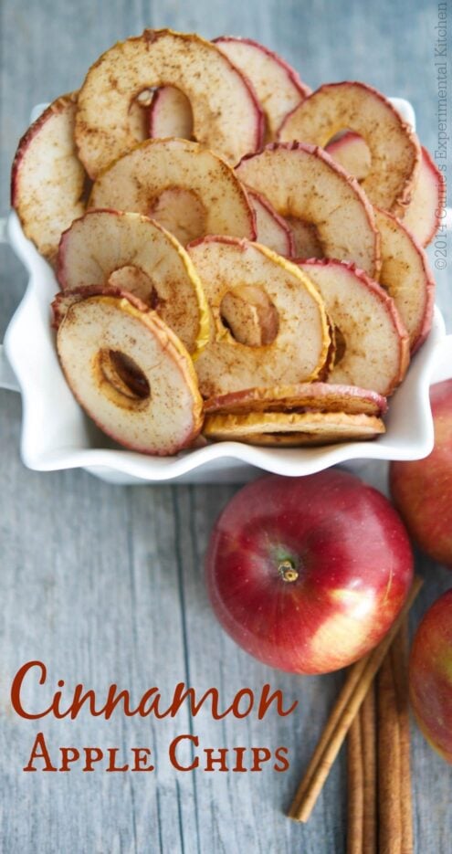 Cinnamon Apple Chips in a bowl on a wooden table.