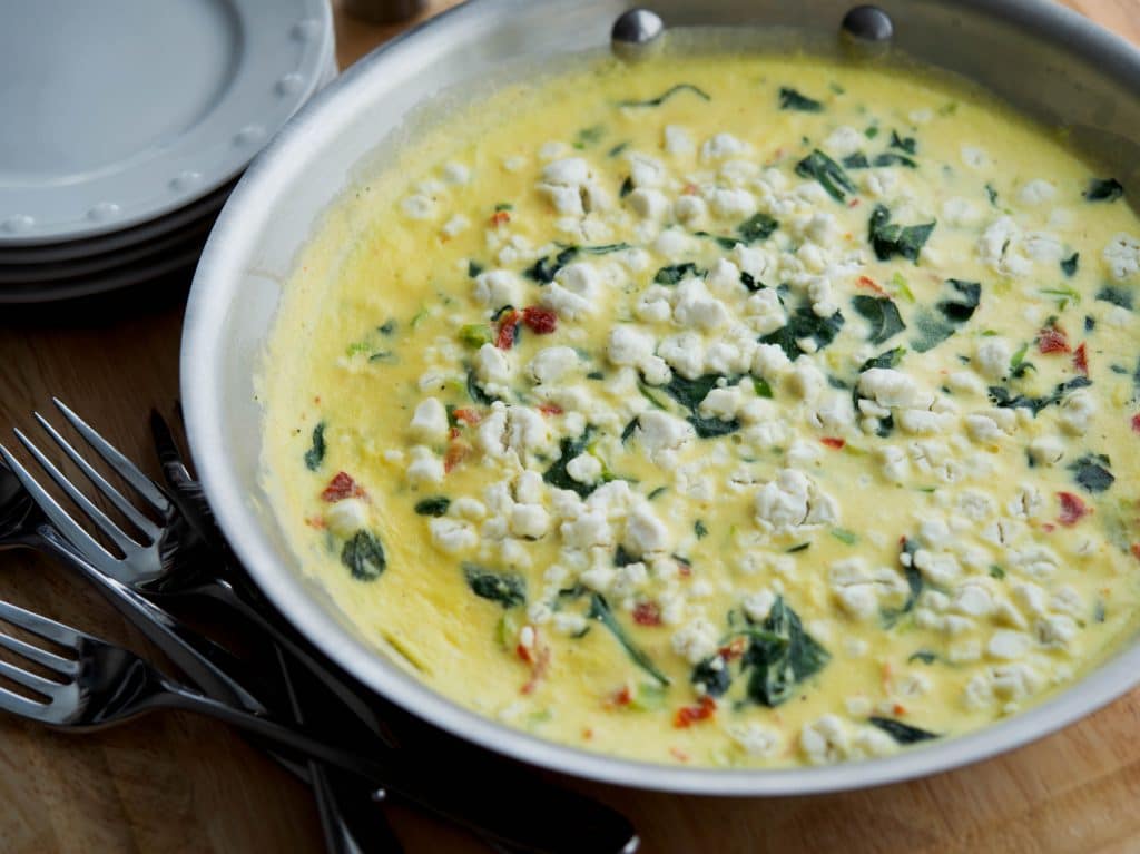 A close up of Florentine Frittata in a stainless steel skillet. 