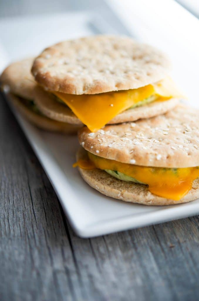Three Turkey Sausage Egg White Flatbread sandwiches on plate. 