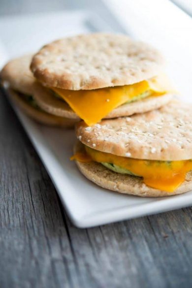 Three Turkey Sausage Egg White Flatbread sandwiches on plate.