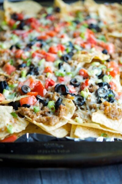 A close up of a slice of nachos