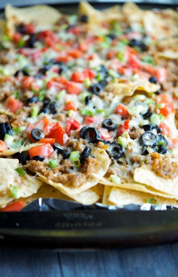 A close up of a slice of nachos