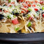 a close up of Italian Nachos on a sheet pan