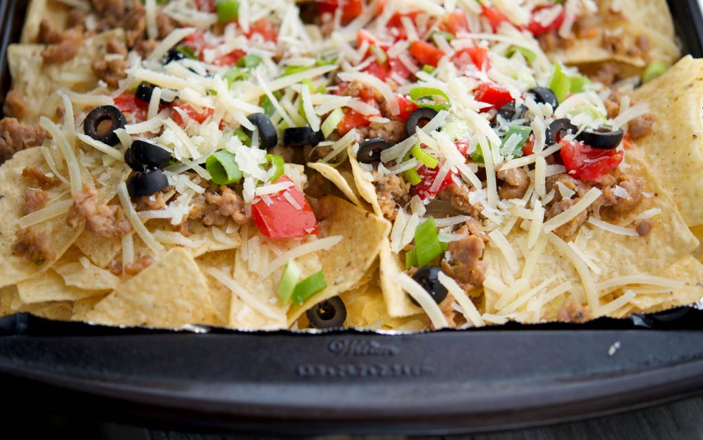 a close up of Italian Nachos on a sheet pan