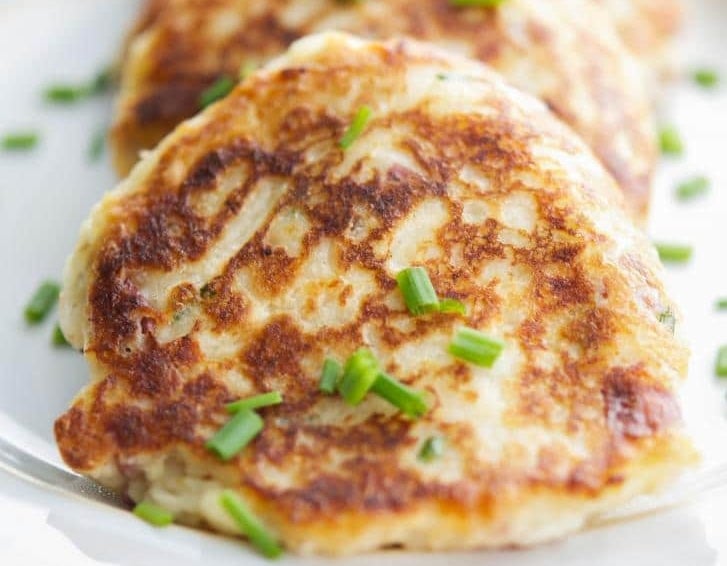 a close up of a loaded potato fritter