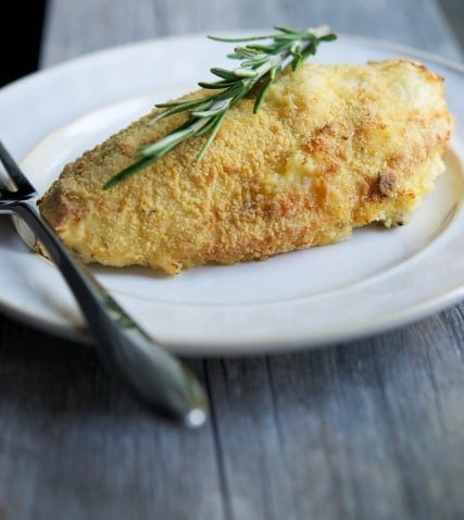 Bone in chicken breasts crusted with a mixture of cornmeal and fresh rosemary; then baked until golden brown is juicy and delicious. 