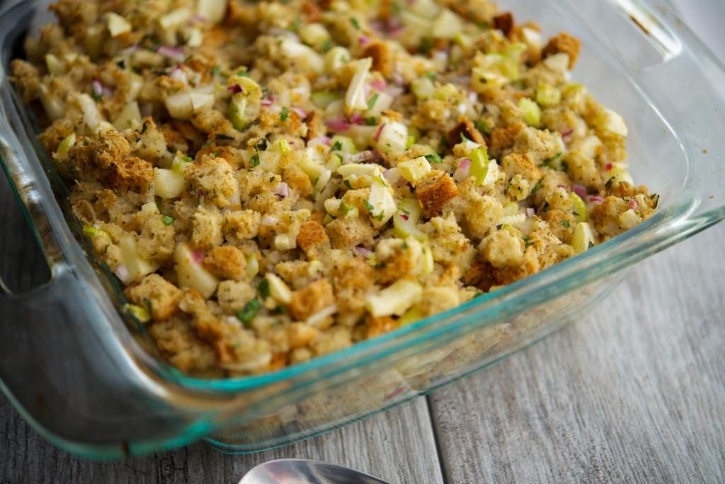 A close up of Apple Bread Stuffing in a glass baking dish. 