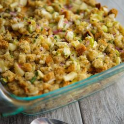 A close up of apple bread stuffing in a glass baking dish.