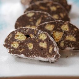 A close up of Chocolate Anisette Salami on a winter plate.