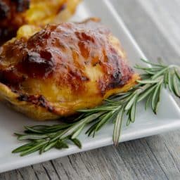 Balsamic Apricot Chicken Thighs with a sprig of rosemary.