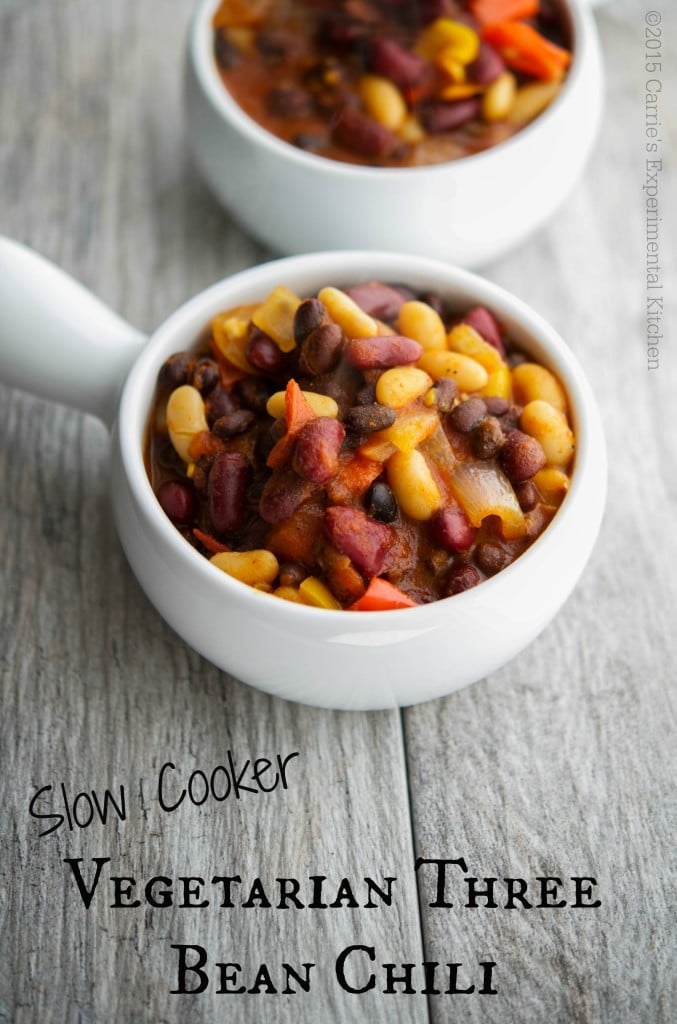 Vegetarian Three Bean Chili in a white soup crock on a wooden table. 