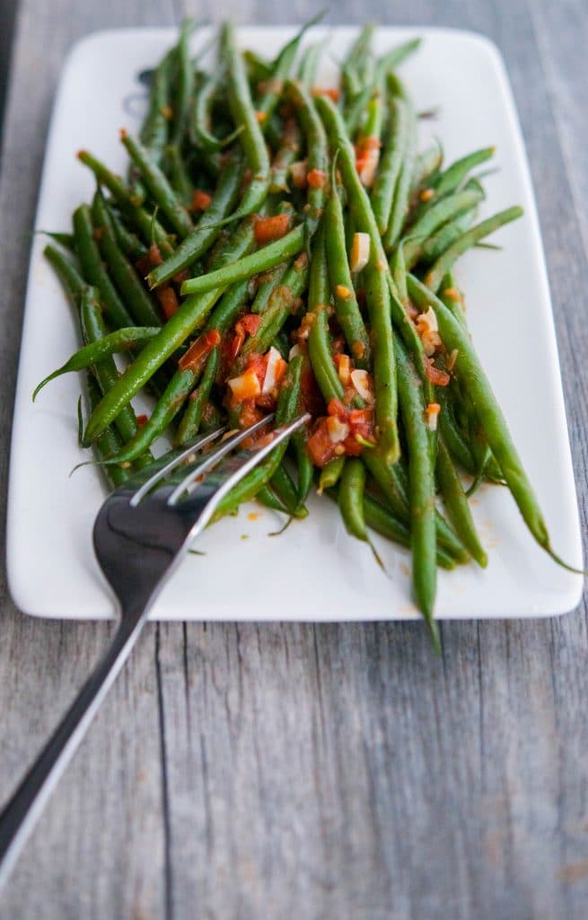 Green beans sautéed with fresh garlic and tomatoes in a light broth make the perfect accompaniment to any meal.