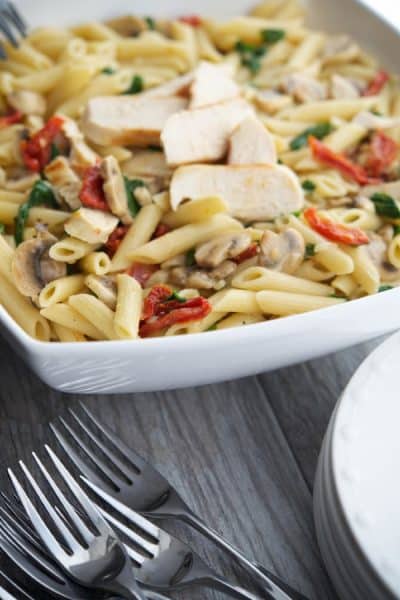 Penne pasta tossed with grilled chicken and seasonal vegetables in a light lemony butter white wine sauce. Makes a tasty quick weeknight meal!