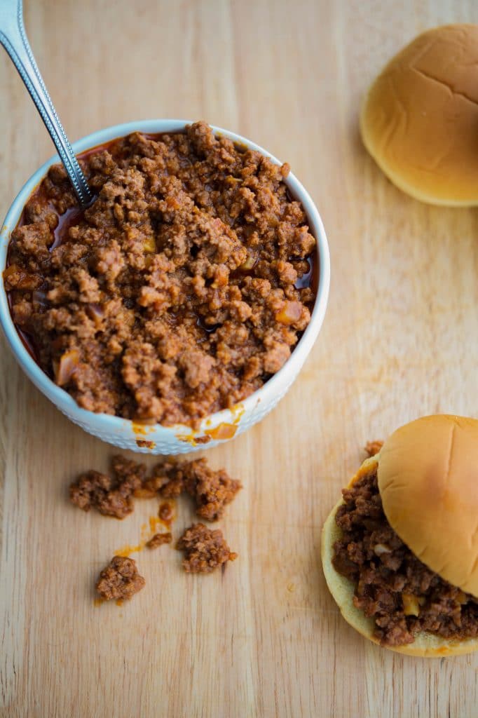 Crock Pot Sloppy Joe\'s in a bowl with a mini sandwich.