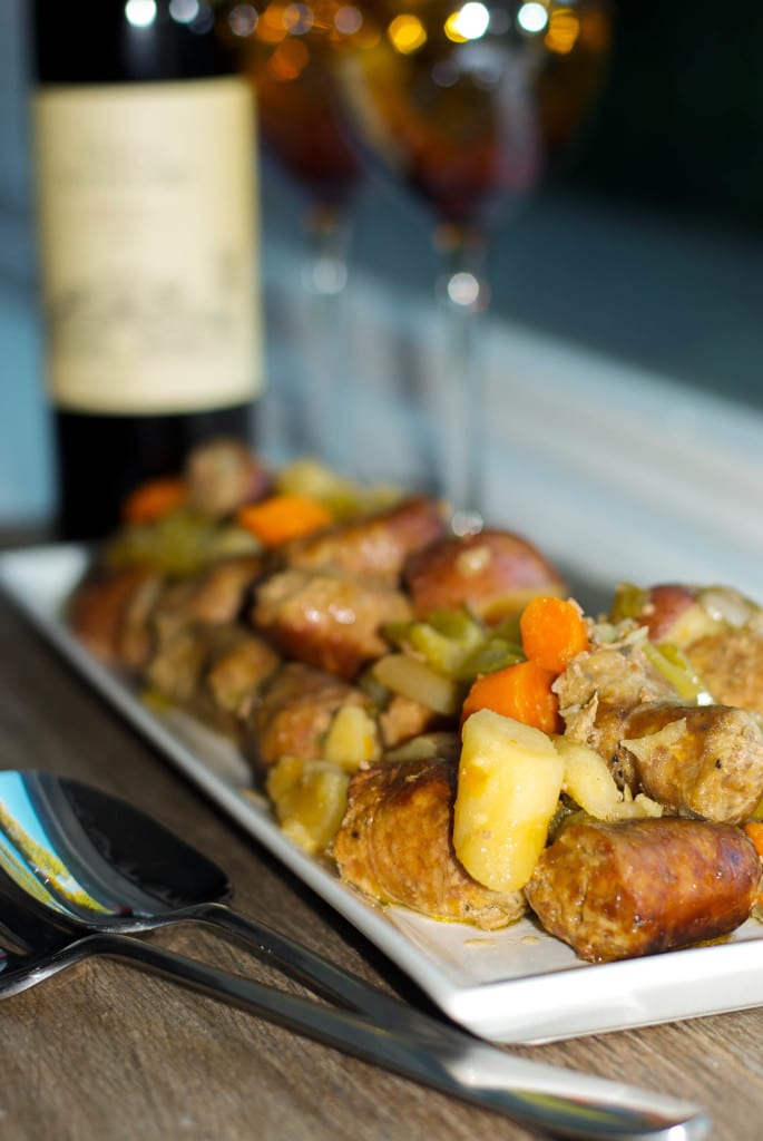 A close up of plate of food on a table, with Sausage and Stew