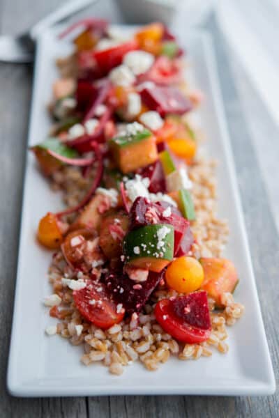 Satorini Farro Salad made with farro, beets, cucumbers, tomatoes, red onion and Feta cheese in a balsamic vinaigrette is filling with a depth of flavors.