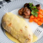 a plate with a piece of grilled chicken topped with bernaise sauce