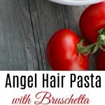A bowl of angel hair pasta topped with bruschetta.