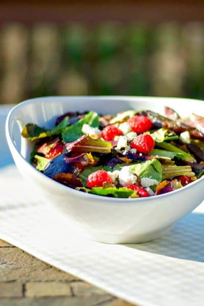 A bowl of salad on a table.