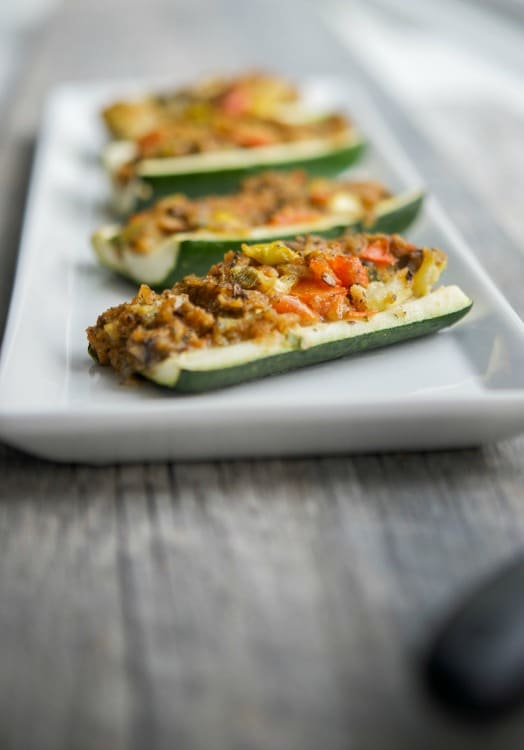 A close up of stuffed zucchini boats. 