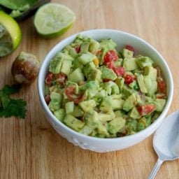 Tomato, Cucumber, Avocado Salad in a white bowl