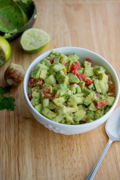 Tomato, Cucumber, Avocado Salad in a white bowl