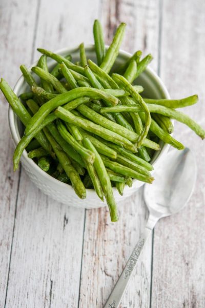 Sea salt roasted green beans in a white bowl.