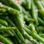 Haricot Verts tossed with ginger, garlic, soy sauce, butter and sesame seeds; then sauteed for a quick weeknight vegetable.