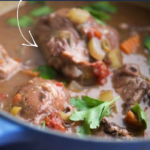 a close up of chicken thighs in a blue pot