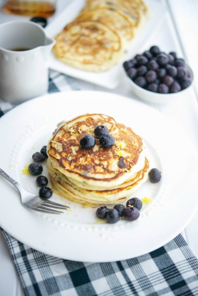 Start you day off right with these healthy, light and fluffy Lemon Ricotta Blueberry Pancakes. They're bursting with flavor!