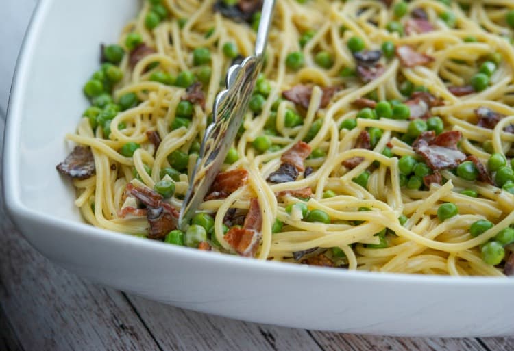 A close up of Spaghetti Carbonara in a white pasta bowl. 