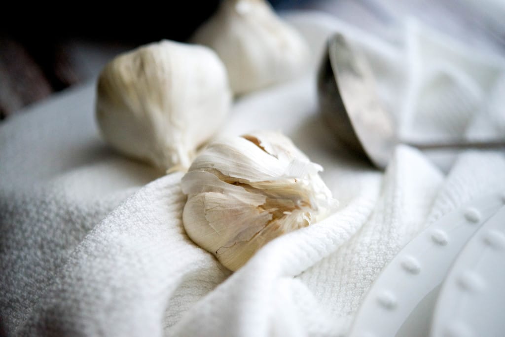 Garlic cloves on a white towel